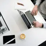 A business professional working on tax documents at a desk.