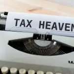 A typewriter with a paper that reads "TAX HEAVEN."