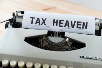A typewriter with a paper that reads "TAX HEAVEN."