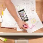 A workspace with tax documents and a smartphone.