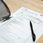 A tax document with a pen on a desk.