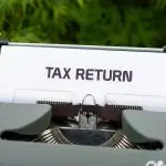 A typewriter with a tax return document inserted.