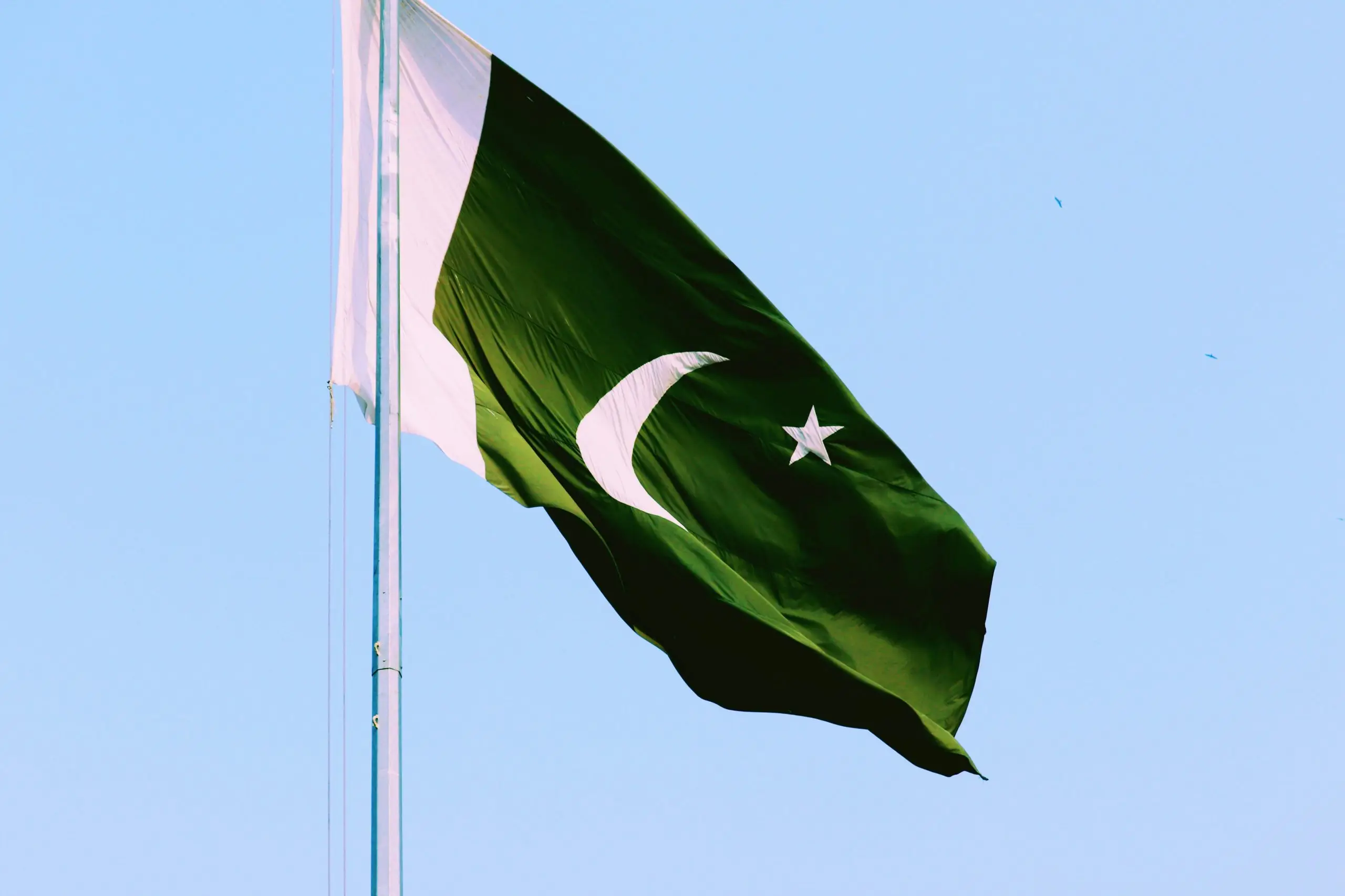 The Pakistan flag waving in the wind.
